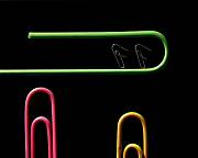 Large green paperclip pointing to the right.