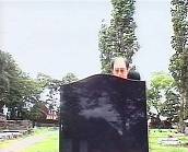 Keith looking over a grave  stone at Narelle.