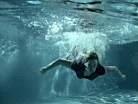 Mother dives into the pool to rescue younger son.